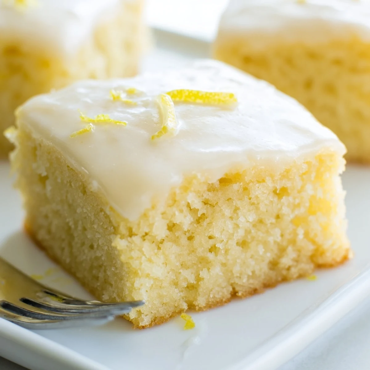 Bright and fluffy Lemon Soda Sheet Cake Squares topped with tangy lemon glaze.  