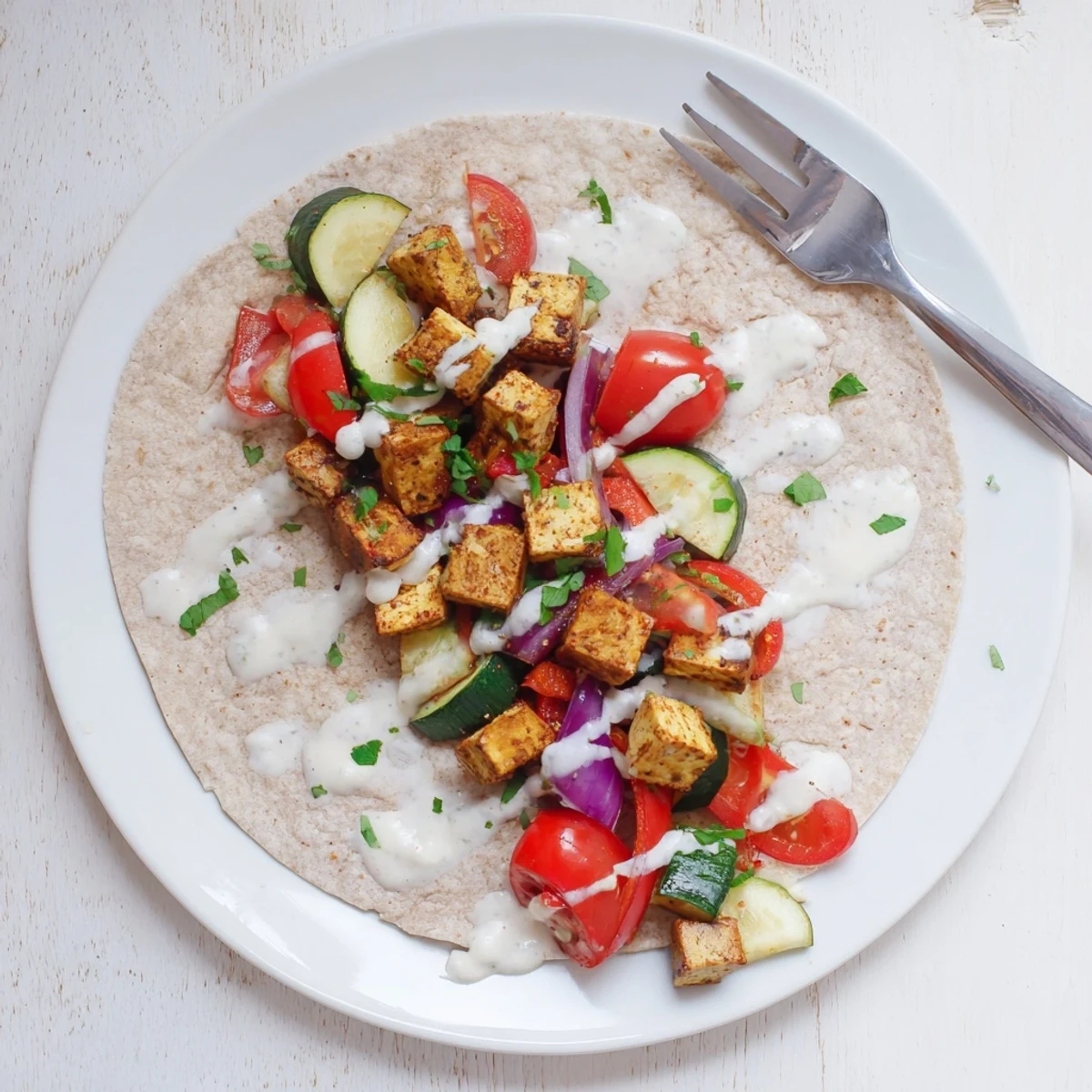 Vibrant vegan viral recipe featuring roasted tofu and fresh veggies in a wrap.  