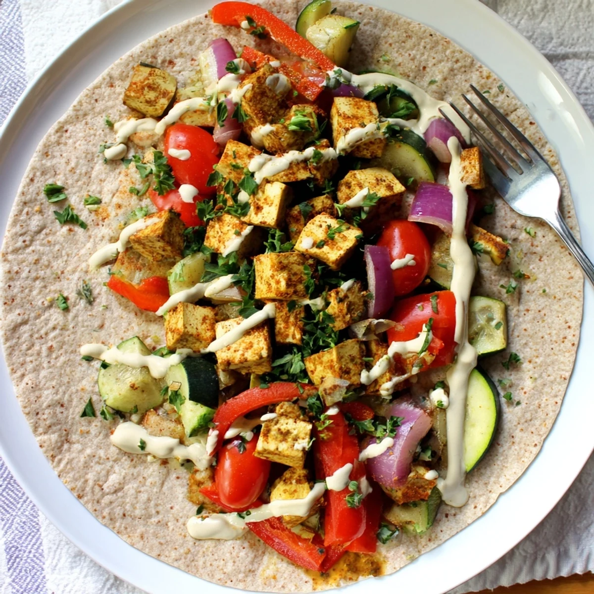 Plant-based vegan viral recipe served in warm pita, drizzled with tahini sauce.