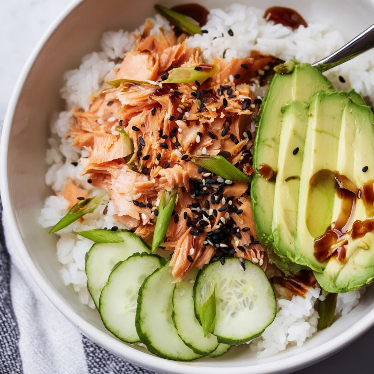 Flavorful leftover salmon & rice bowl, featuring pickled ginger and drizzled soy sauce.