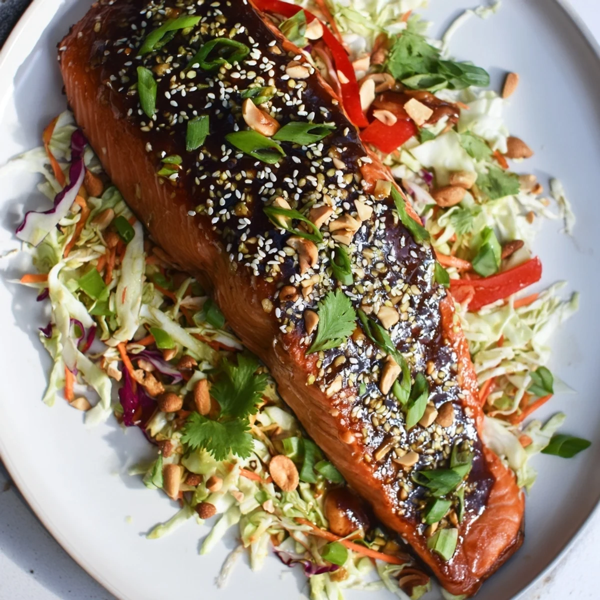 Imagine tender teriyaki salmon atop a bed of vibrant Asian slaw, a healthy and satisfying meal.