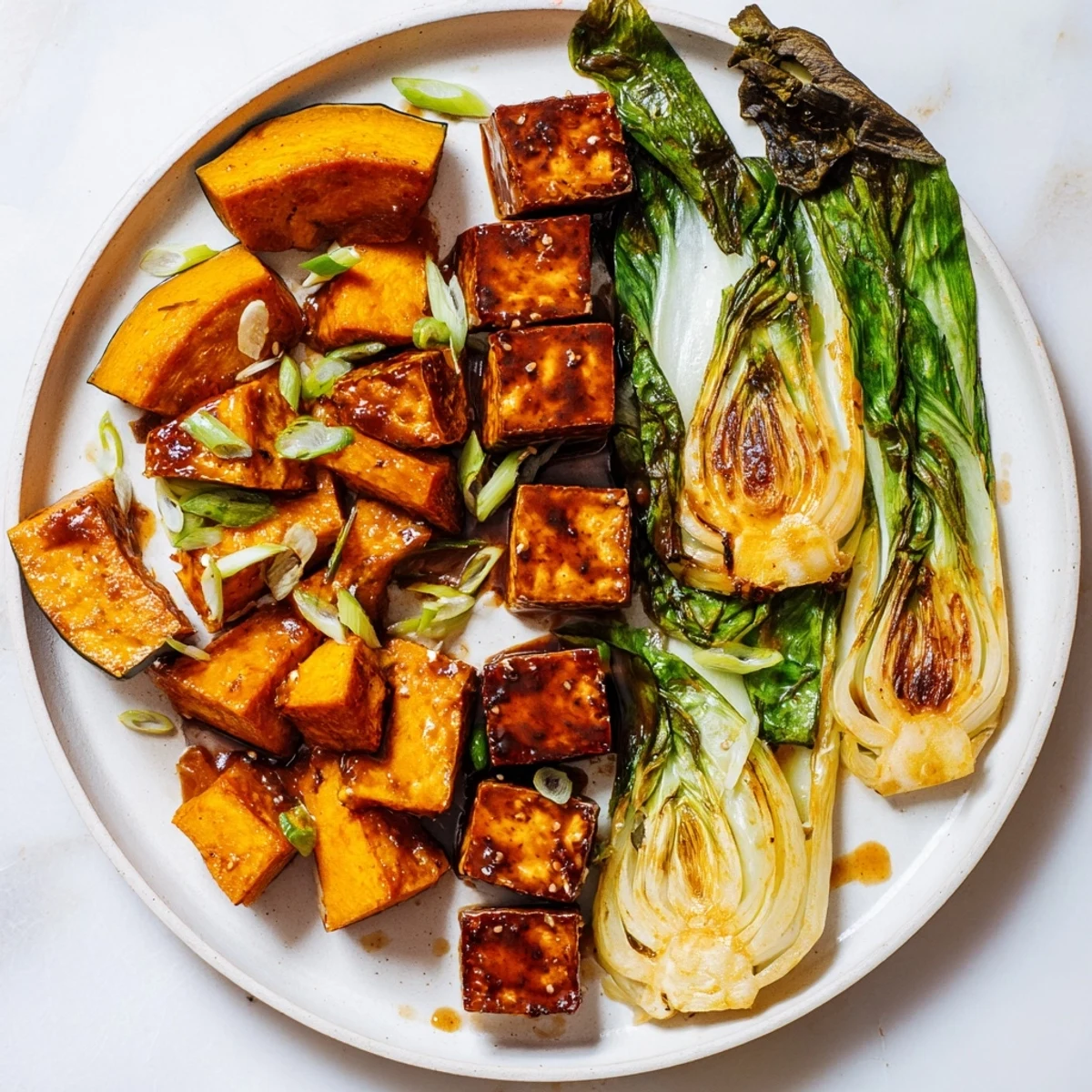Savory Miso-Glazed Tofu glistens next to vibrant squash, a flavorful vegan main dish ready to serve.