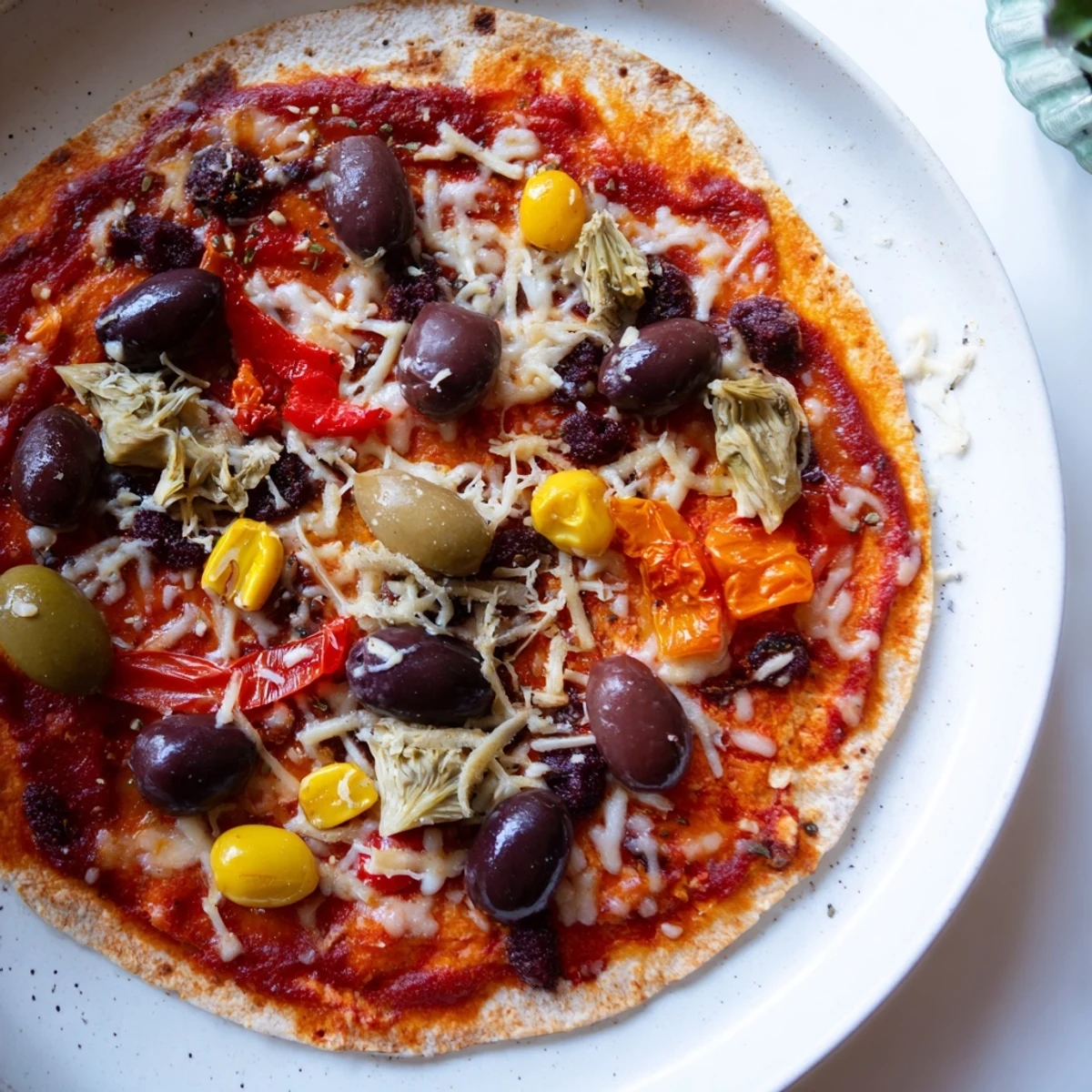 Crispy tortilla pizza, a quick meal with melted cheese and delicious pantry toppings.