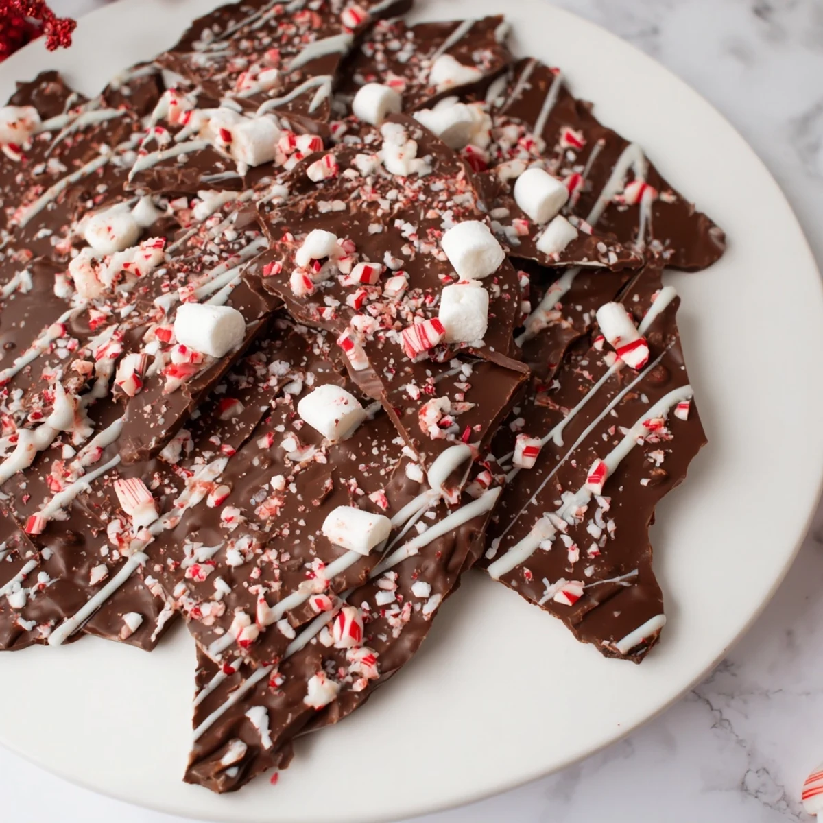 Homemade Hot Chocolate Bomb Bark with a sprinkle of cocoa and mini marshmallows, a delicious dessert.