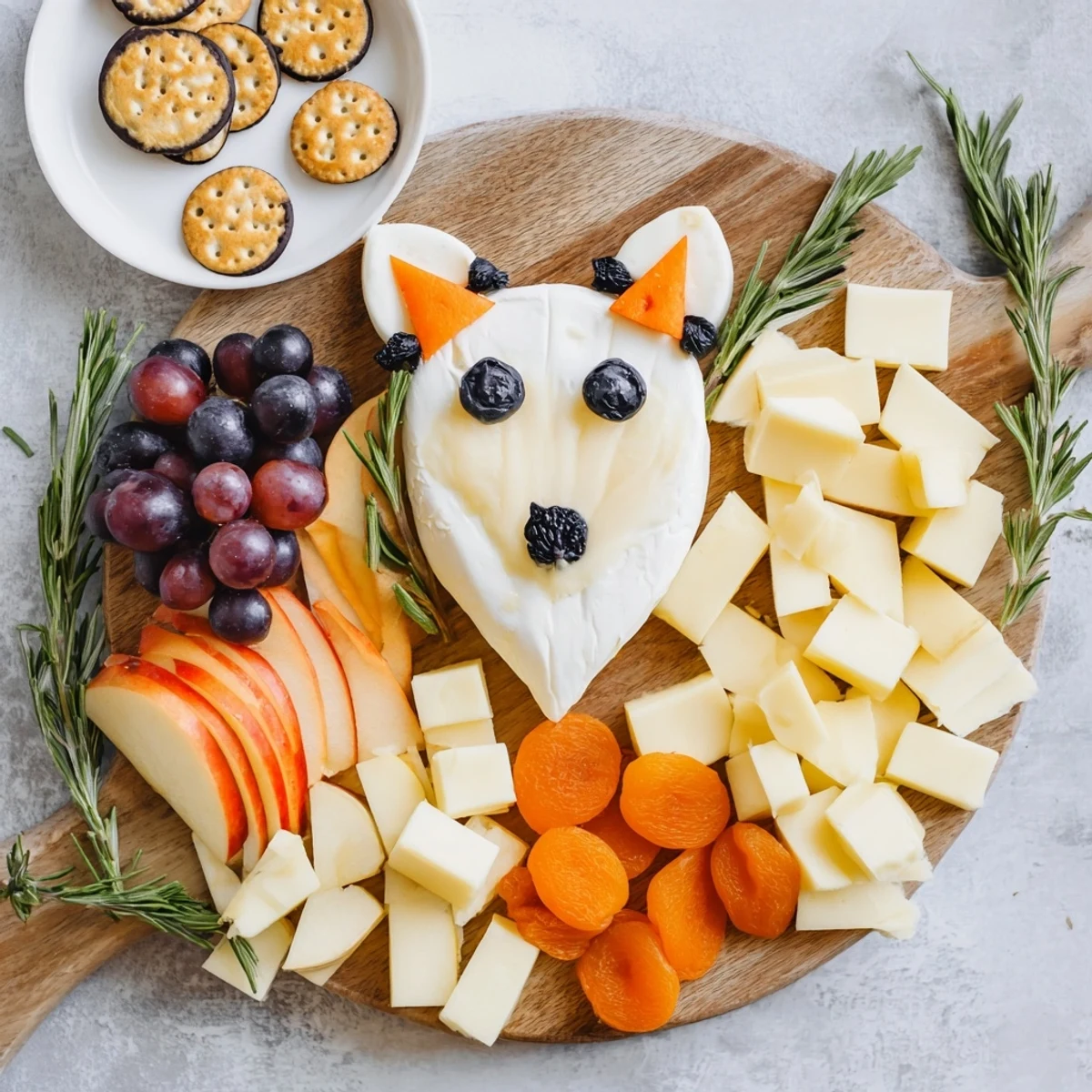 This festive Whimsical Fox Fall Treat Board features an artful cheese fox surrounded by autumnal snacks.