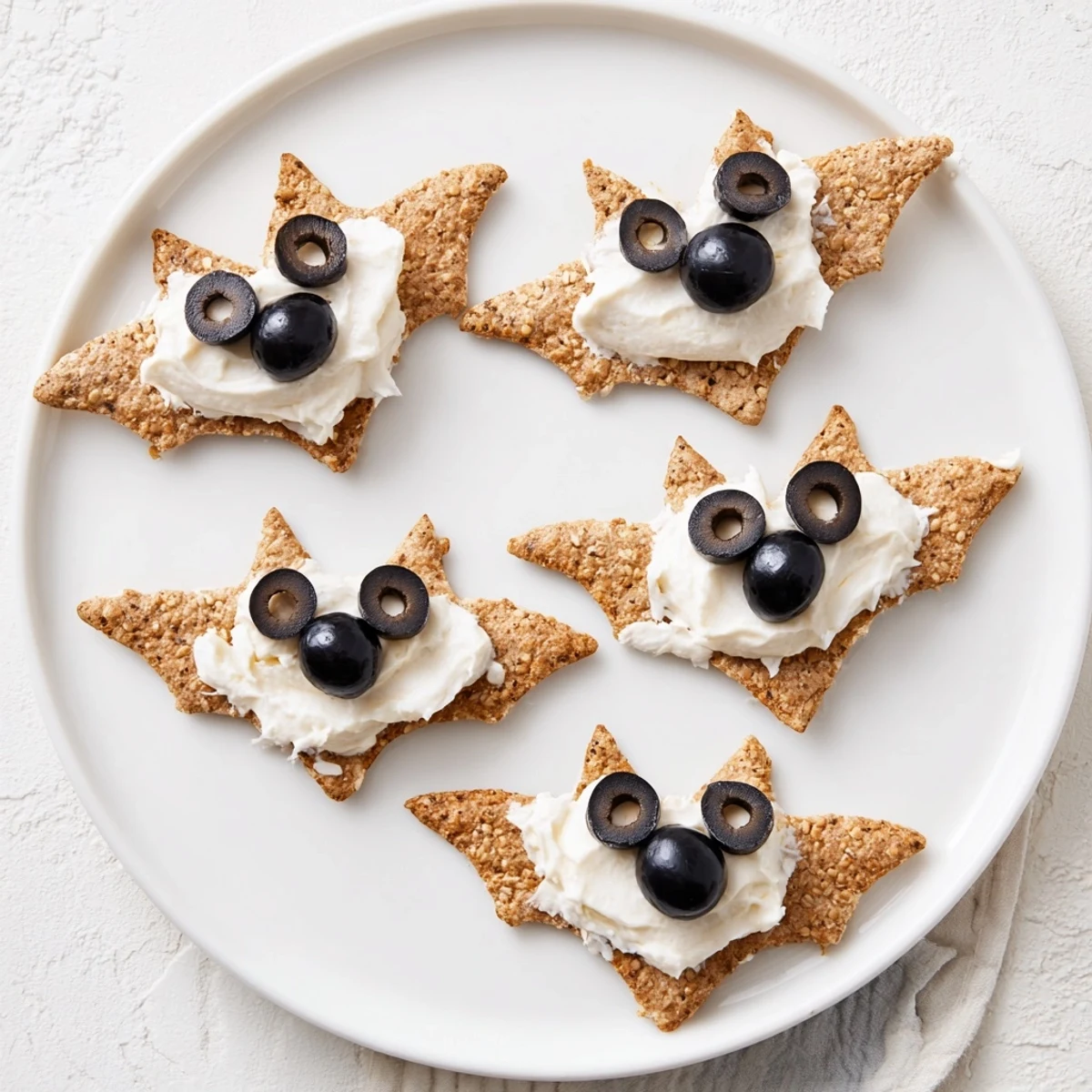 Enjoy the whimsical Flying Bat Halloween Snack Board, complete with creamy, bat-shaped cracker appetizers.