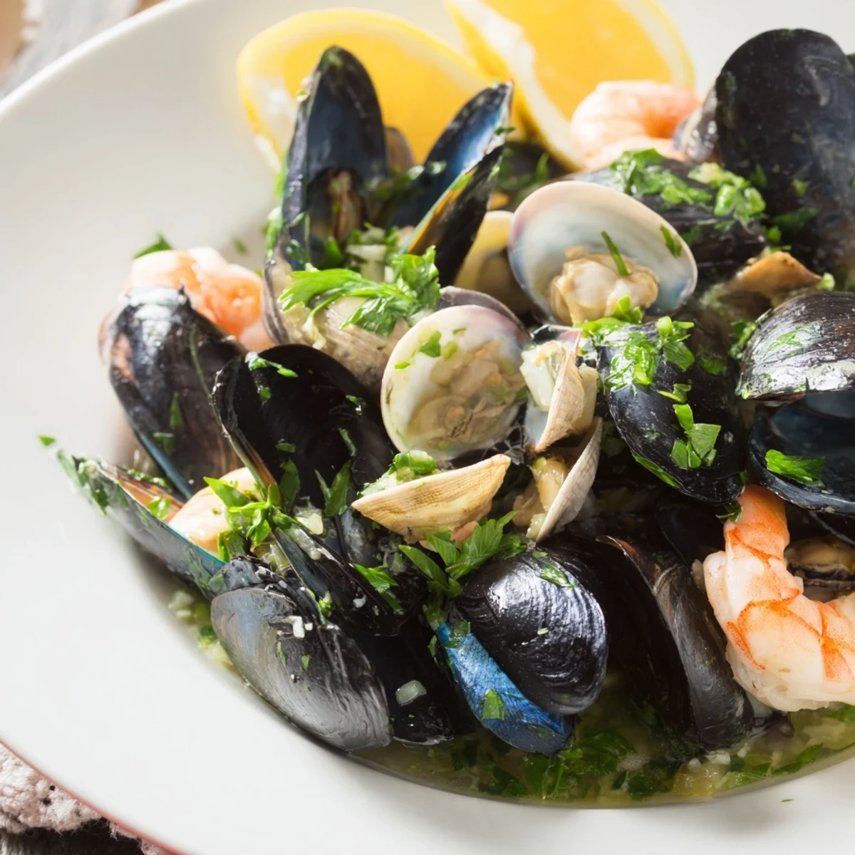 Freshly cooked Shellfish & Seafood Medley arranged with parsley, ready for a delightful and fragrant dinner.