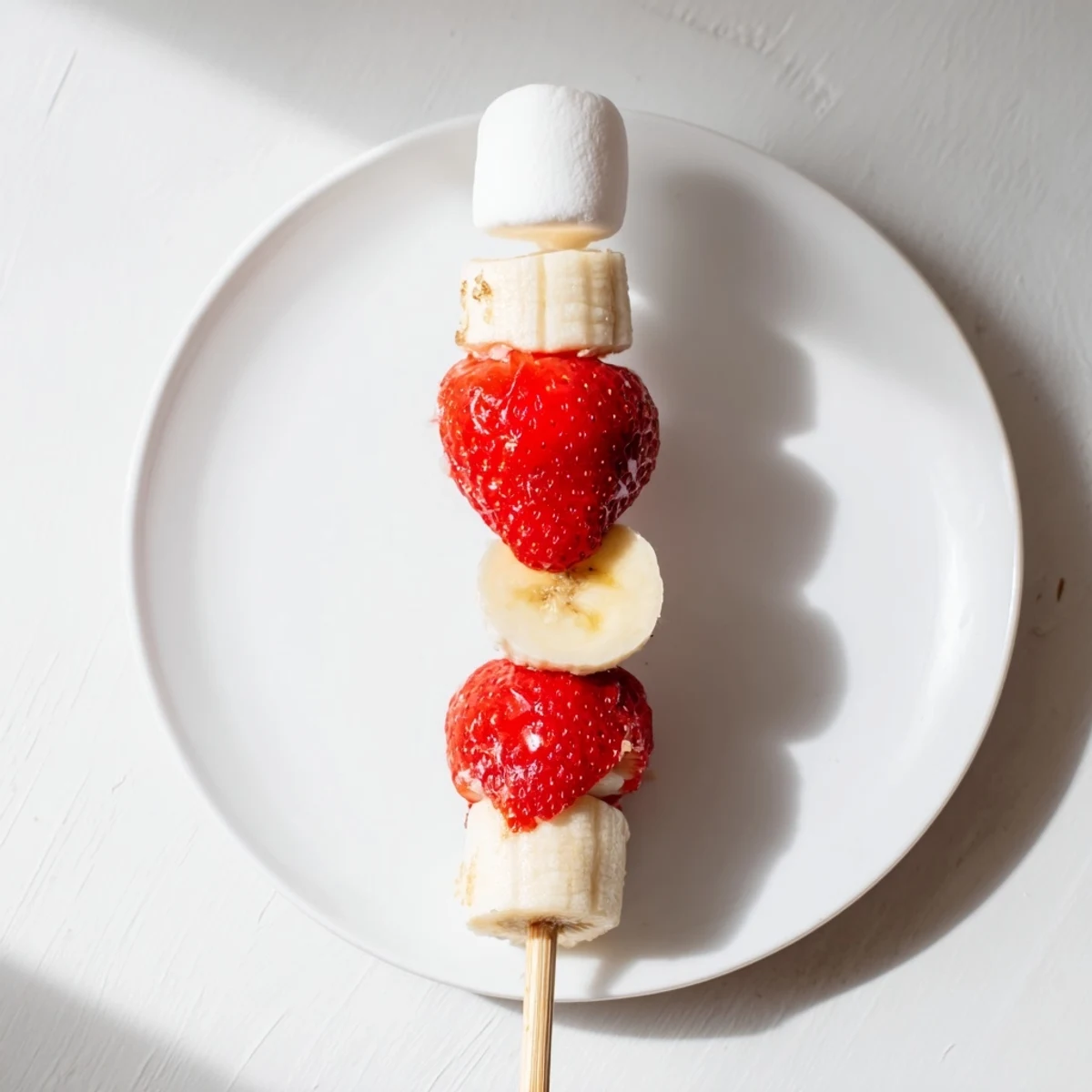 Vibrant Strawberry Banana Santa Sticks: Festive fruit snack ready for serving at holiday parties.