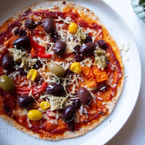 Crispy tortilla pizza, a quick meal with melted cheese and delicious pantry toppings.
