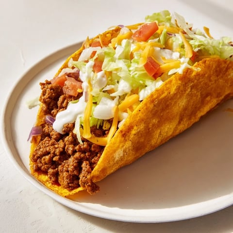 Mouthwatering Cheesy Gordita Crunch Tacos: a close-up of the delicious messy filling layered inside.