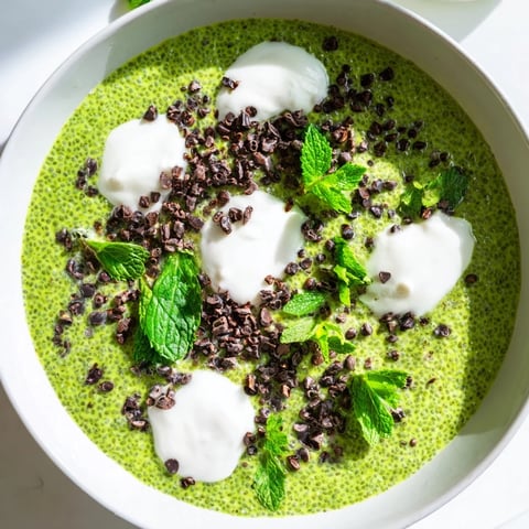 Vibrant Grinch Green Mint Matcha Chia Pudding, a festive vegan breakfast with fresh mint and berries.