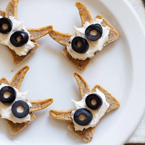 A spooky Flying Bat Halloween Snack Board overflowing with vibrant veggies, cheeses, and sweet treats.