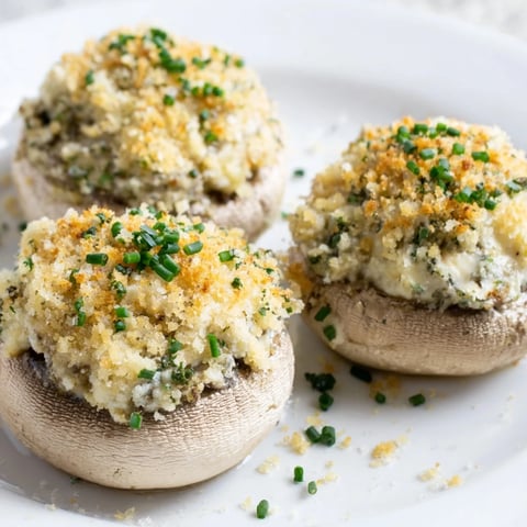 Golden, bubbly, baked stuffed mushroom caps arranged in a beautiful, delicious appetizer ring.