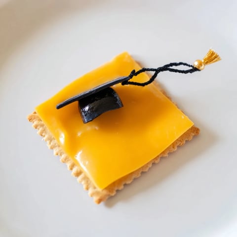 Delectable Graduation Cap Snacks ready for your party, featuring cheese caps and licorice tassels.