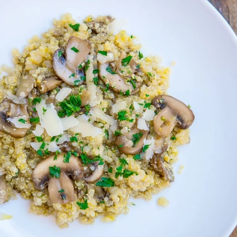 Creamy mushroom quinoa risotto with Parmesan cheese, ready to serve, a flavorful main.