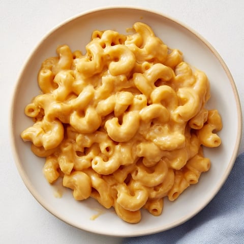 Warm, golden butternut squash mac and cheese, a creamy comfort food favorite, ready to serve.