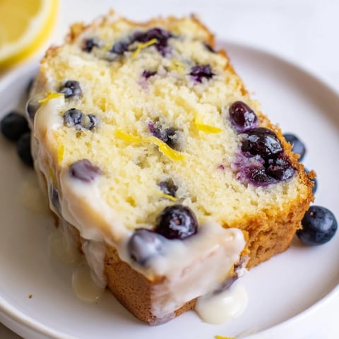 Moist Lemon Blueberry Yogurt Loaf, studded with fresh blueberries, ready for a delicious slice.