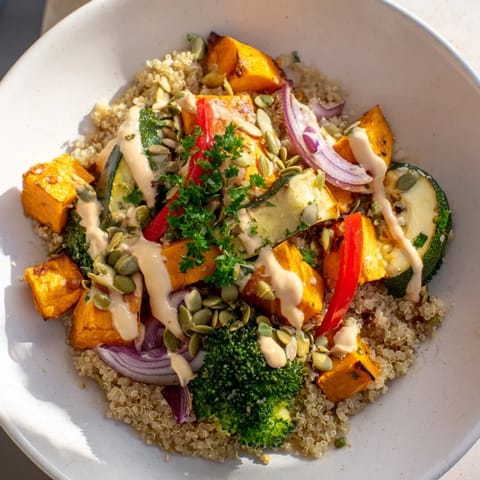 Hearty quinoa bowl featuring tender roasted seasonal vegetables, ideal for a vegan lunch or dinner.