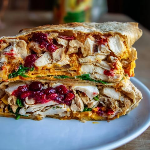 Golden, crisp tortilla wraps showcasing a flavorful Moist Maker Chicken Wrap filled with juicy roast chicken.