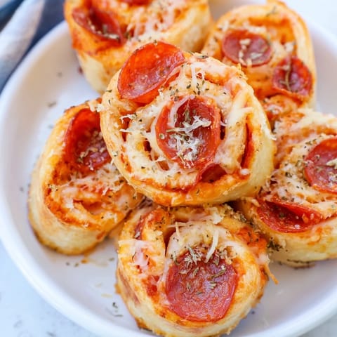 Golden air fryer pizza rolls, crispy exterior with melty cheese, ready for dipping.