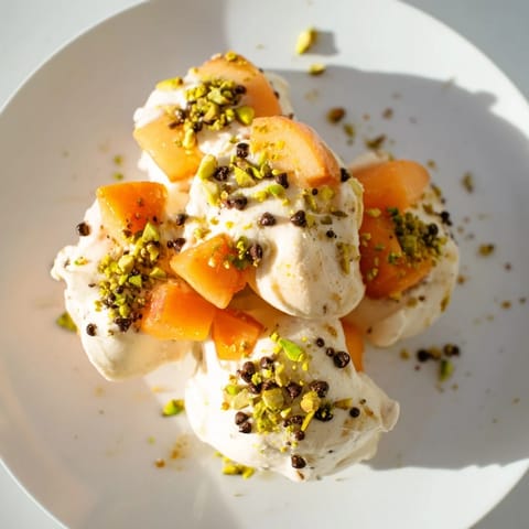 Frozen peach yogurt bites, creamy white with tiny peach pieces, frozen and ready to eat.