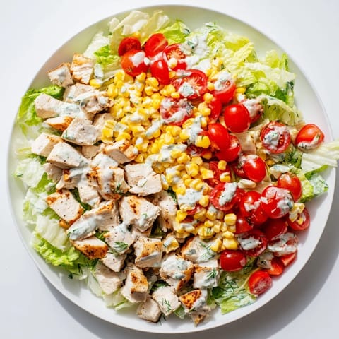 Close-up of Ranch Chicken Chopped Salad tossed in creamy ranch dressing, with sharp cheddar and tender chicken pieces.