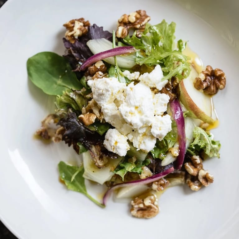 This Spiced Honey and Date Goat Cheese Salad boasts vibrant greens topped with spiced honey dressing.