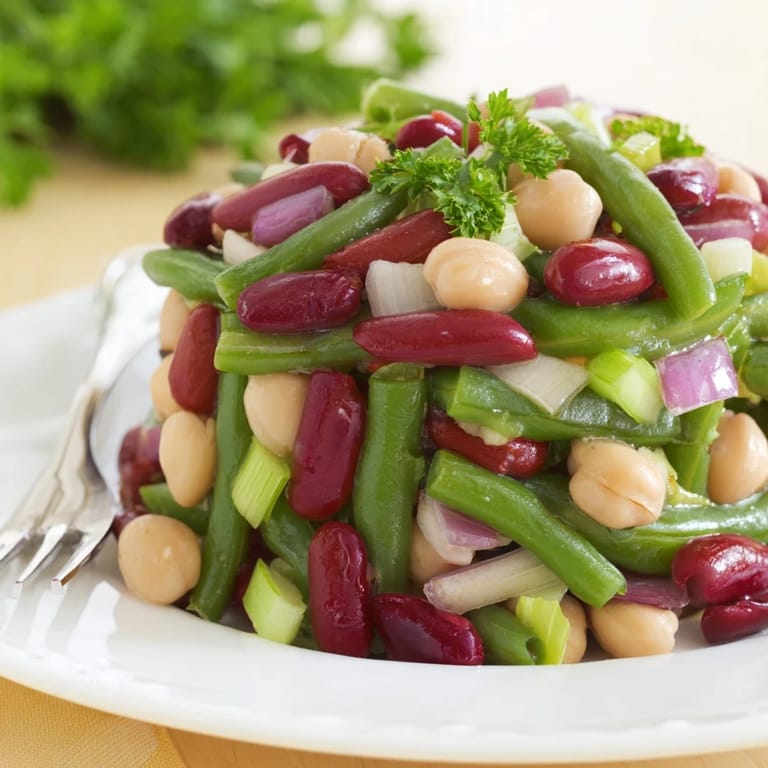Serving suggestion for Three-Bean Salad in a clear glass bowl, perfect for summer picnics and potlucks.
