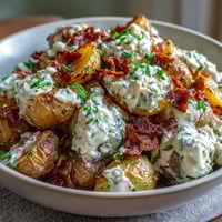 A hearty BBQ baby shower loaded baked potato salad with smoky bacon, cheddar, and fresh herbs.  